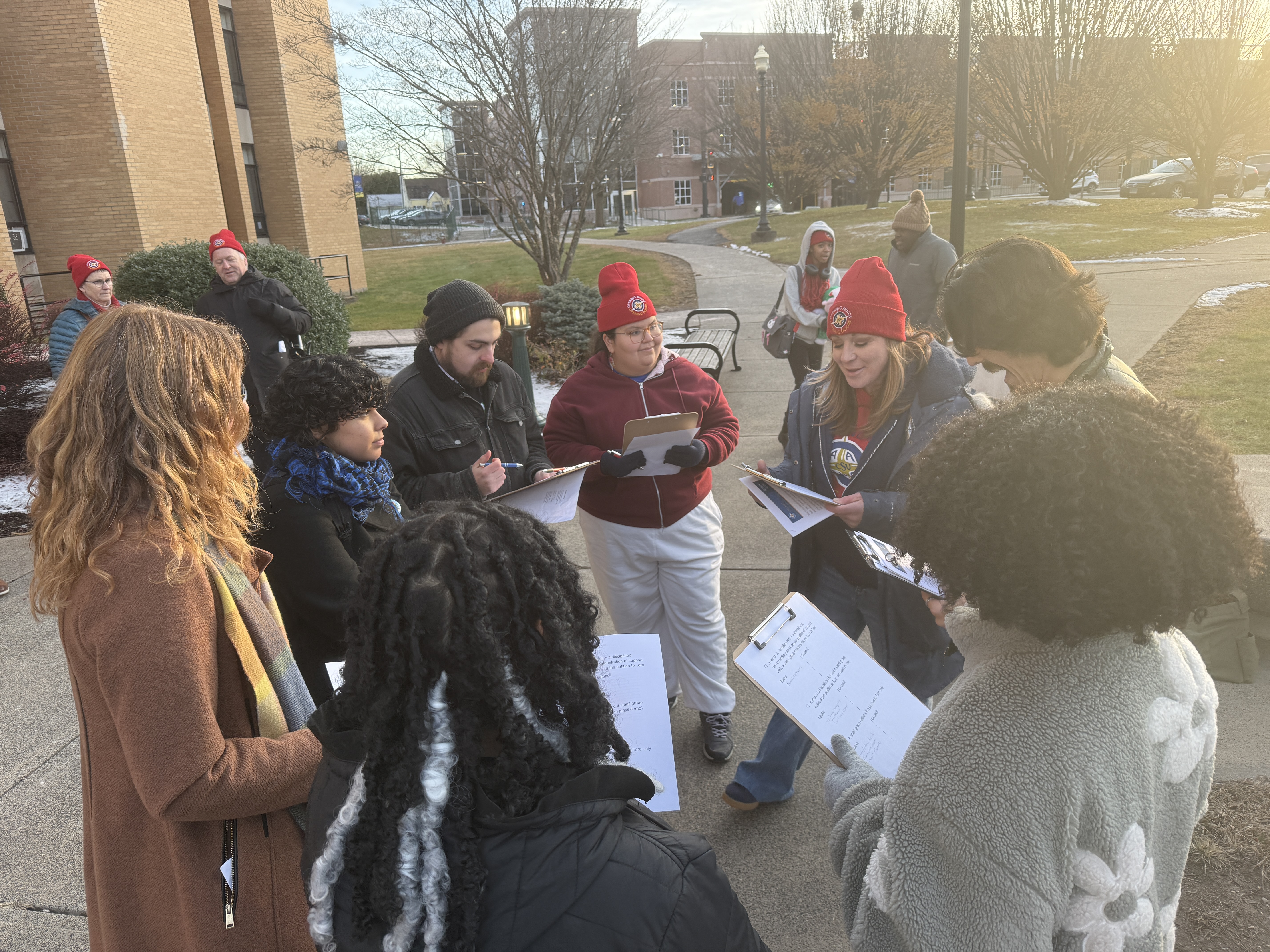 Students and faculty circle up to review the plan before marching to deliver the petition.